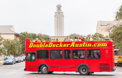 Red Tour Bus for Double Decker Austin driving around 35 guest to sight see Austin's local attractions and sights.